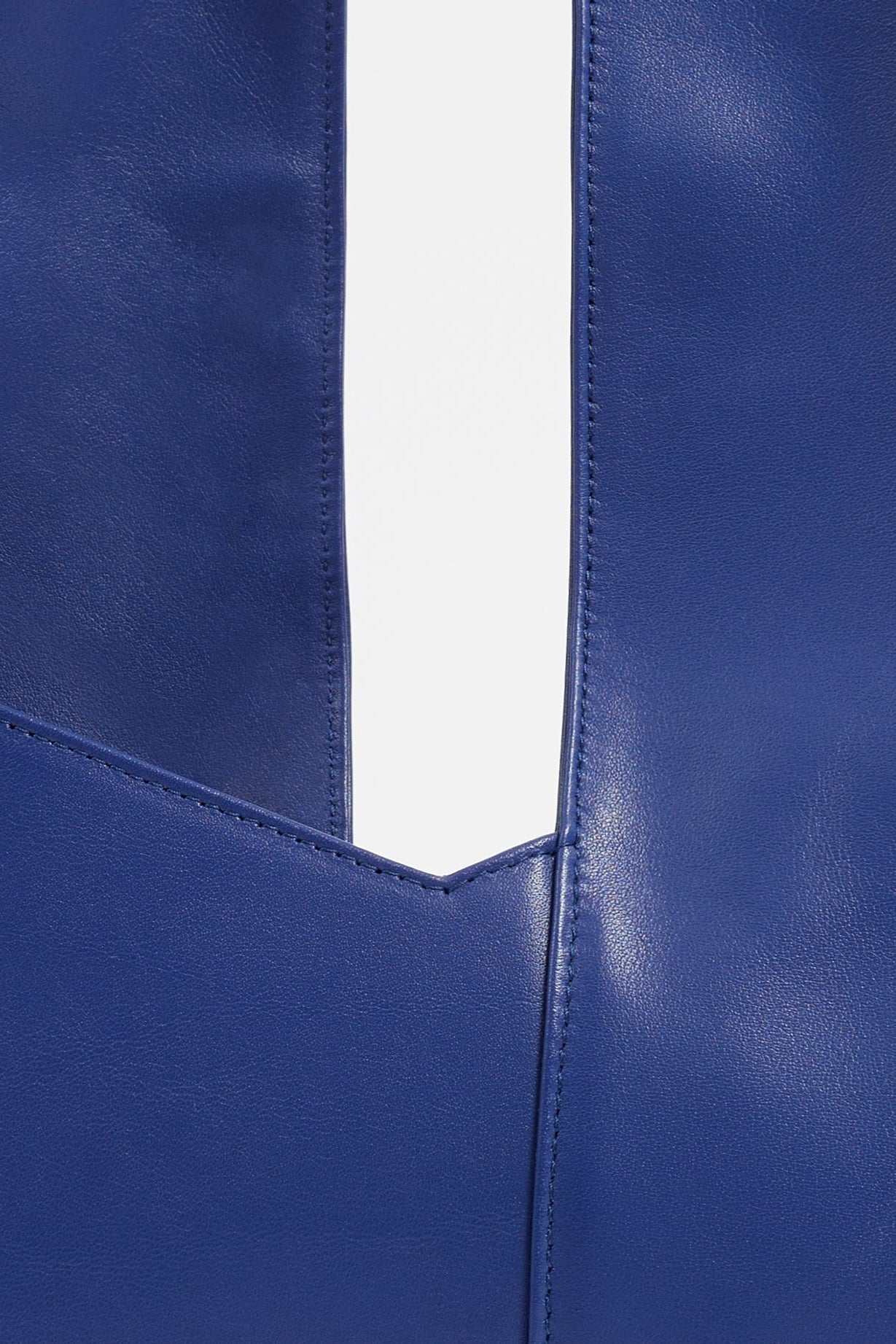 Details of AYT Studio 'Dual' tote bag made of blue Italian leather and lining with full-length zipper, handle with sophisticated scarf detail