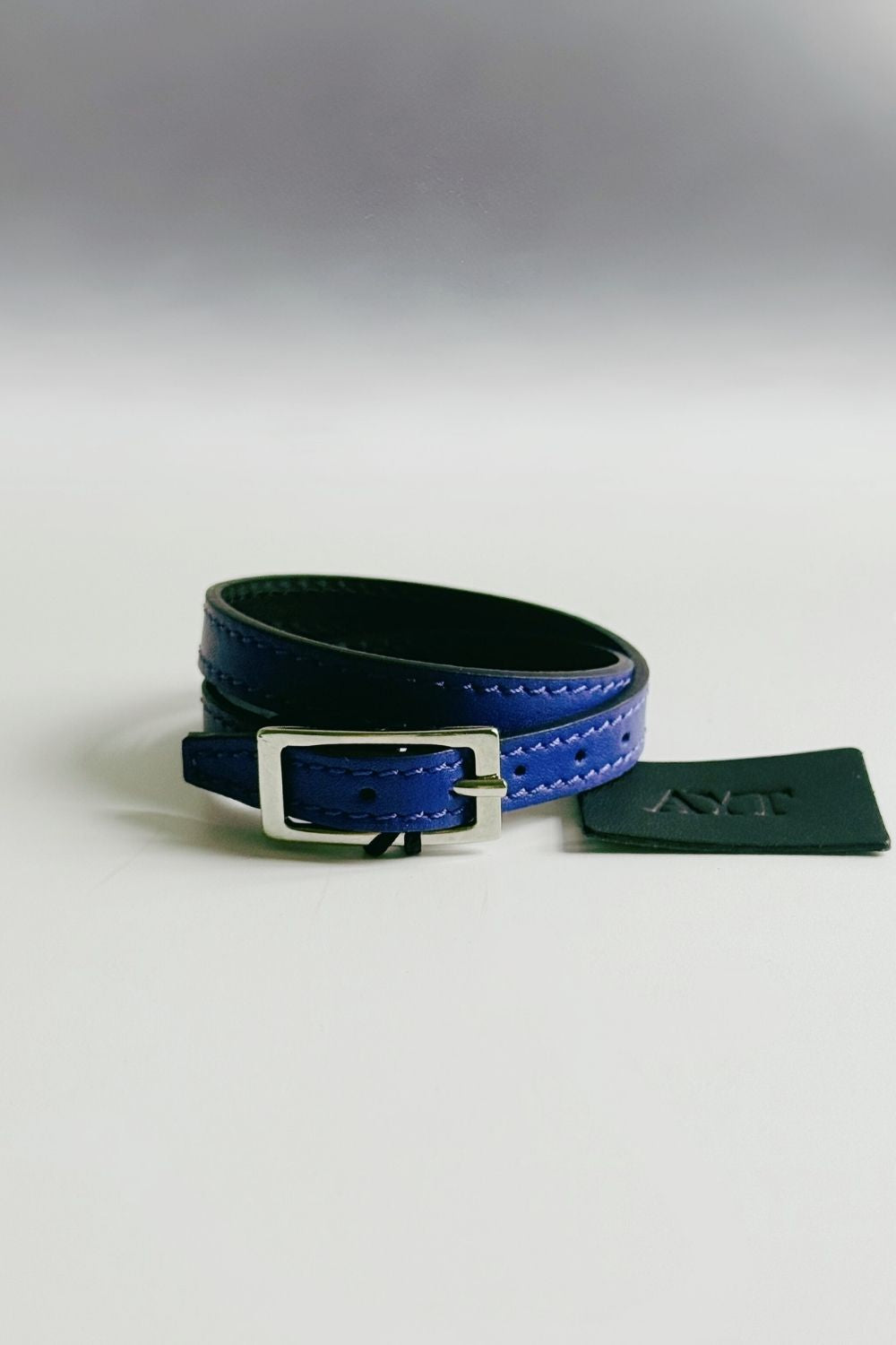 Flat view of AYT Studio unisex blue Italian leather double bracelet with silver buckle hardware