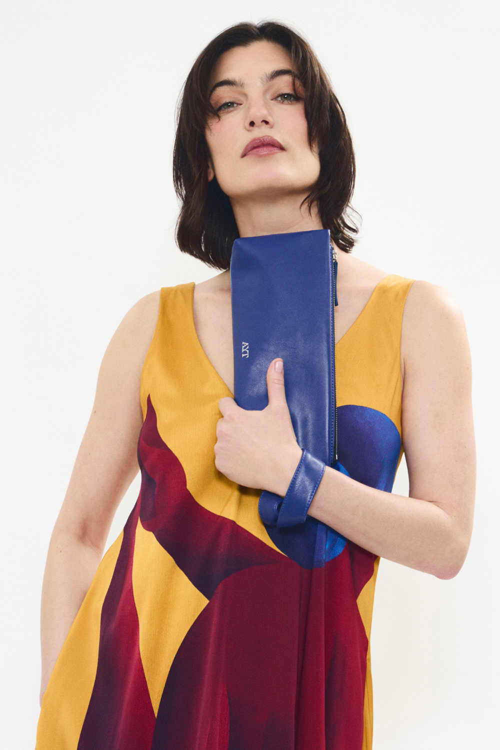 Model wearing 'FOULARD' Baguette bag in smooth blue Italian leather with knotted scarf-inspired handle and signature blue lining