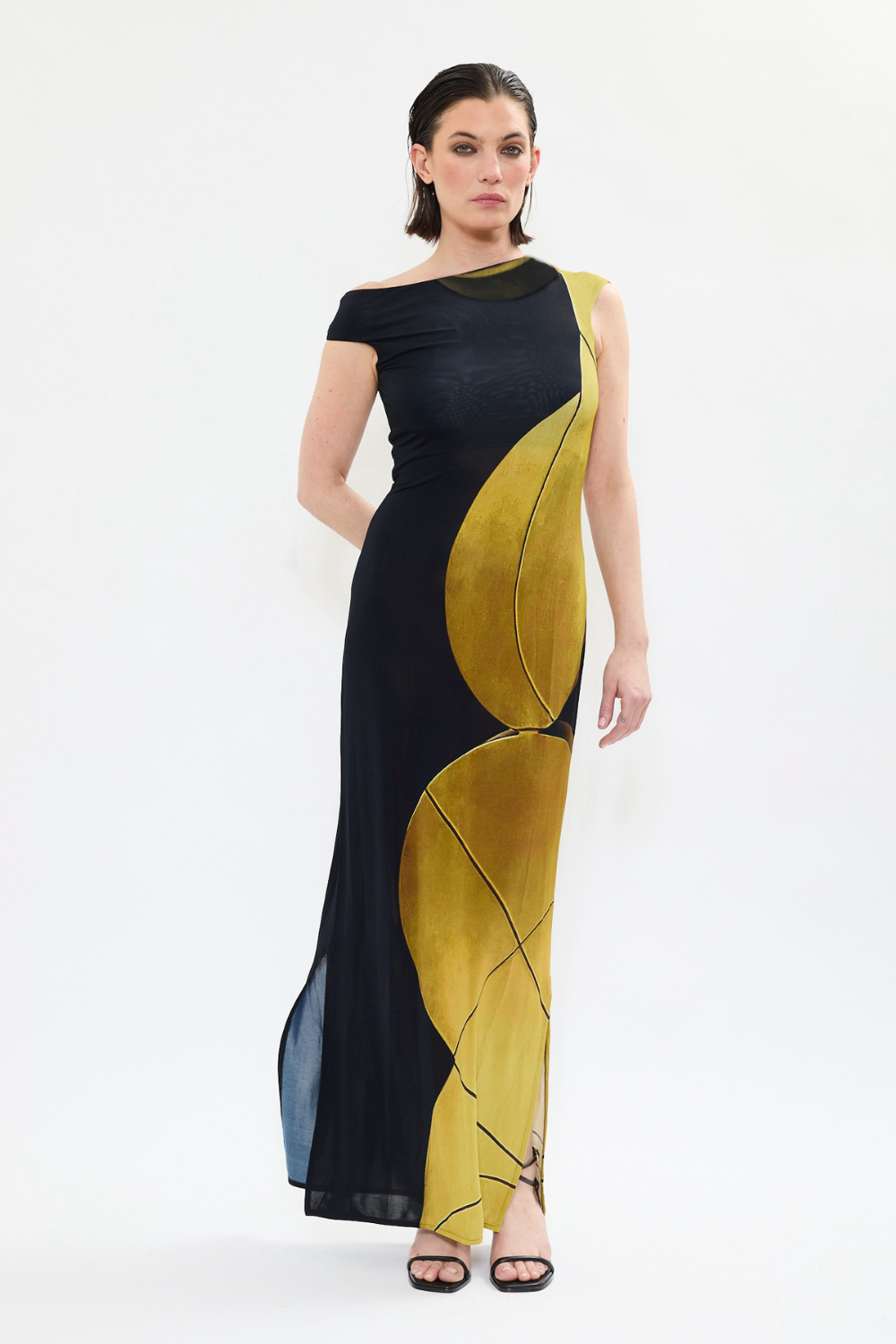 AYT STUDIO x REMED 'AURA' fluid viscose and elastane maxi dress with asymmetrical shoulder and side slits in printed black and gold, inspired by 'Femme & sphère.'
