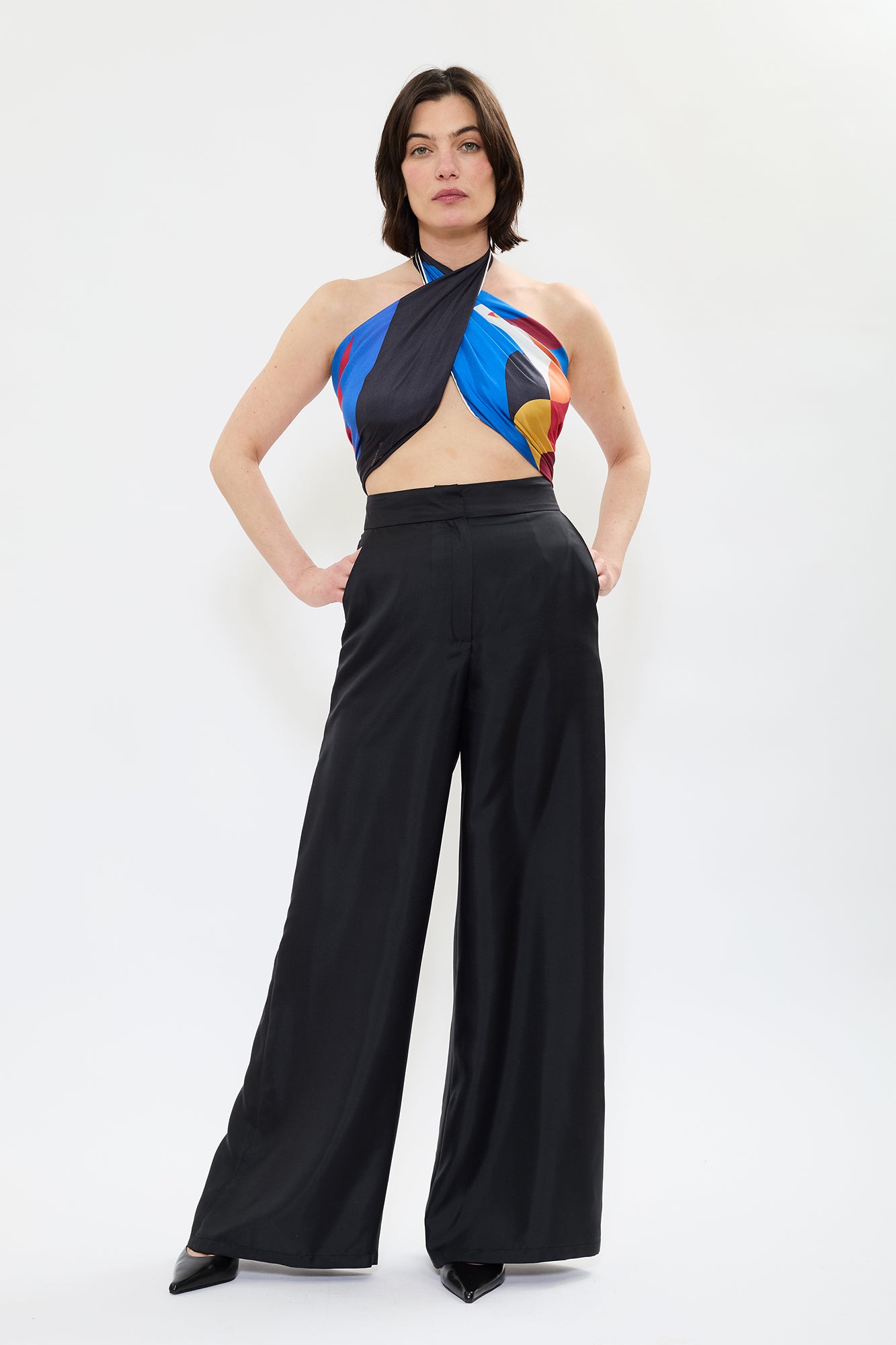 Model styled in AYT STUDIO x French painter REMED 100% twill silk scarf crafted in Como, Italy in a stylized, colorful graphic print inspired by REMED's painting ‘Bel Envol.' Fluid, versatile accessory for styling. 85 x 85 cm.
