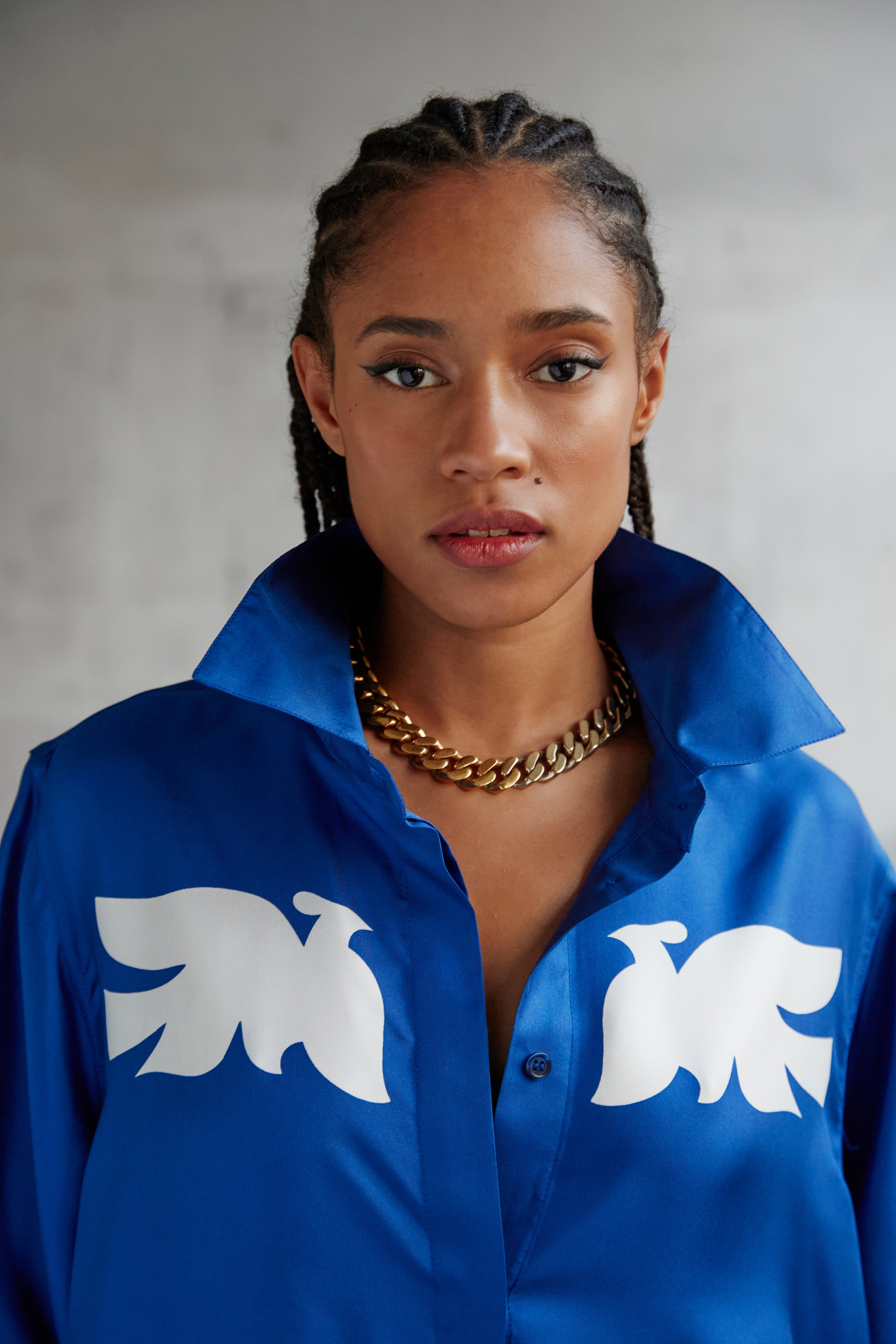 Model styling AYT Studio x French artist REMED 'CLOUD OF BIRDS' 100% twill silk button down shirt with structured collar, long sleeves. Lightweight and versatile for day-to-night, relaxed, unisex style. Inspired by REMED's 'Bel Envol.'