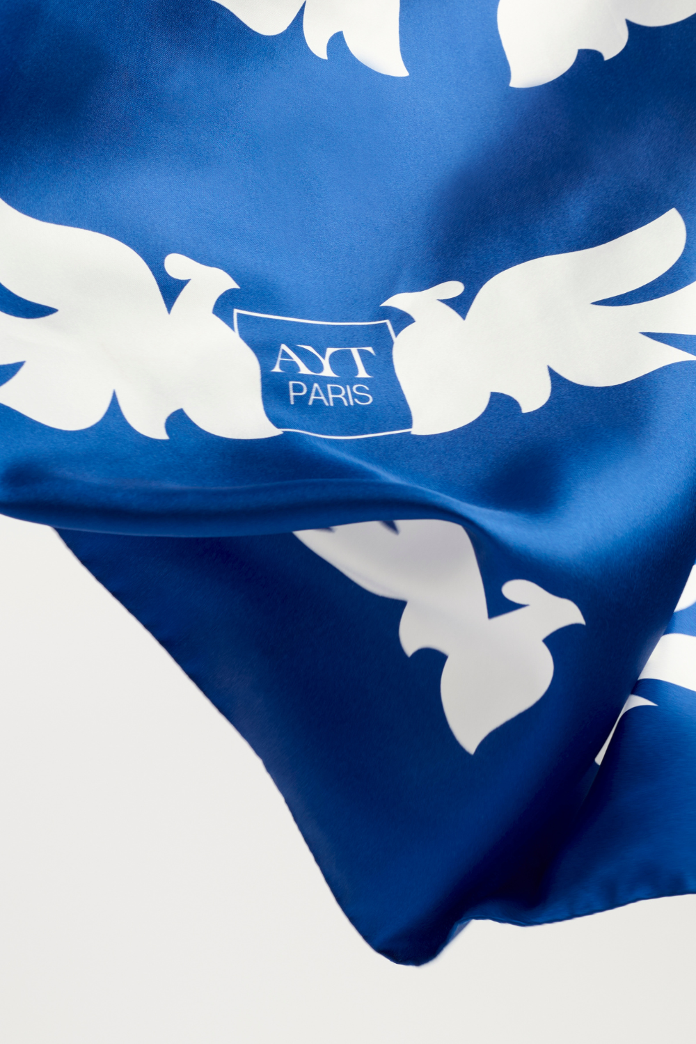 Details of AYT Studio x French artist REMED 'CLOUD OF BIRDS' 100% twill silk scarf crafted in Como, Italy, hand-finished with rolled edges. Lightweight, versatile accessory. Inspired by 'Bel Envol'