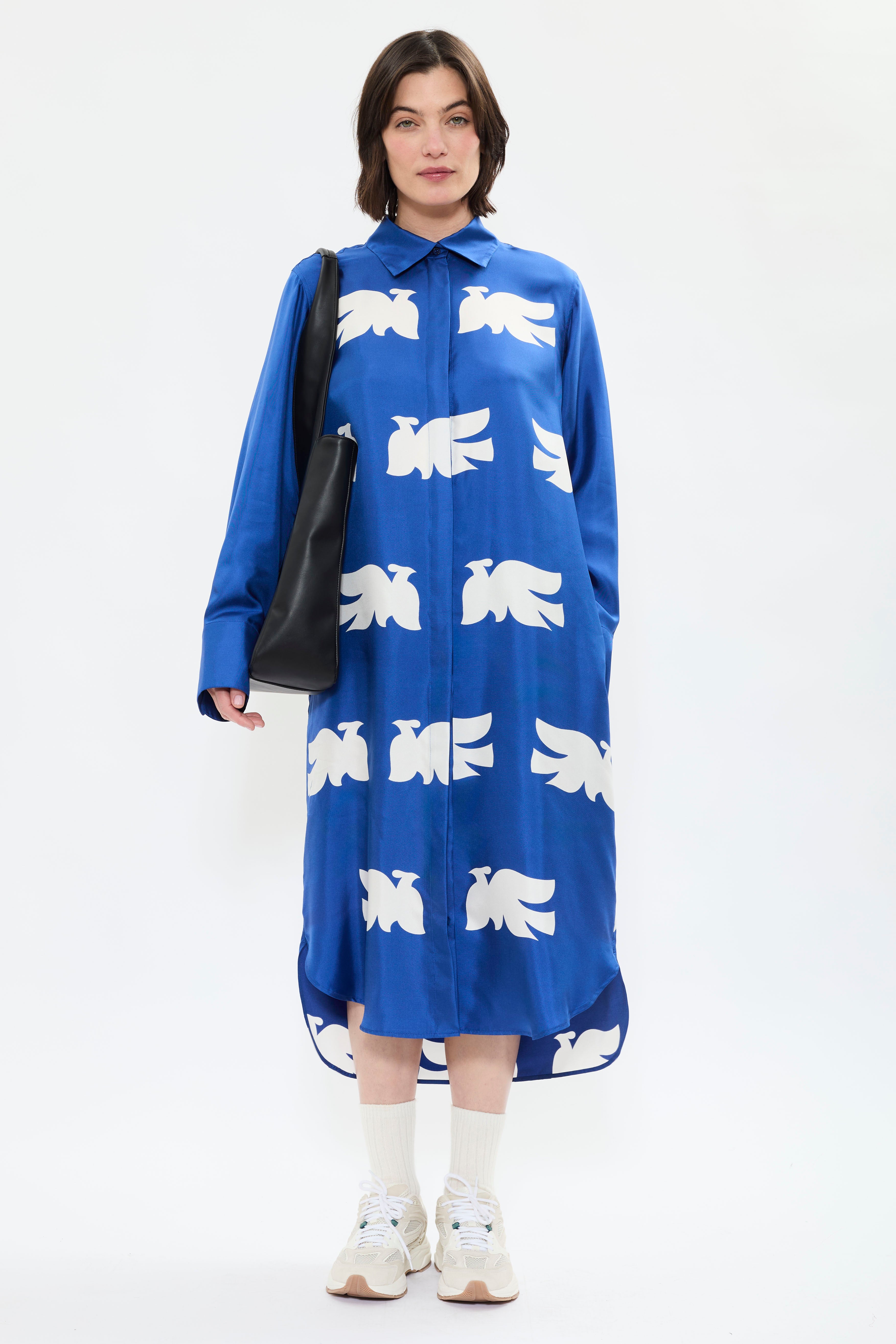 Front view of AYT Studio x French artist REMED 'CLOUD OF BIRDS' 100% twill silk button shirt dress with structured collar, long sleeves, and discreet pockets. Lightweight and versatile for day-to-night, relaxed, feminine style. Inspired by REMED's 'Bel Envol.'