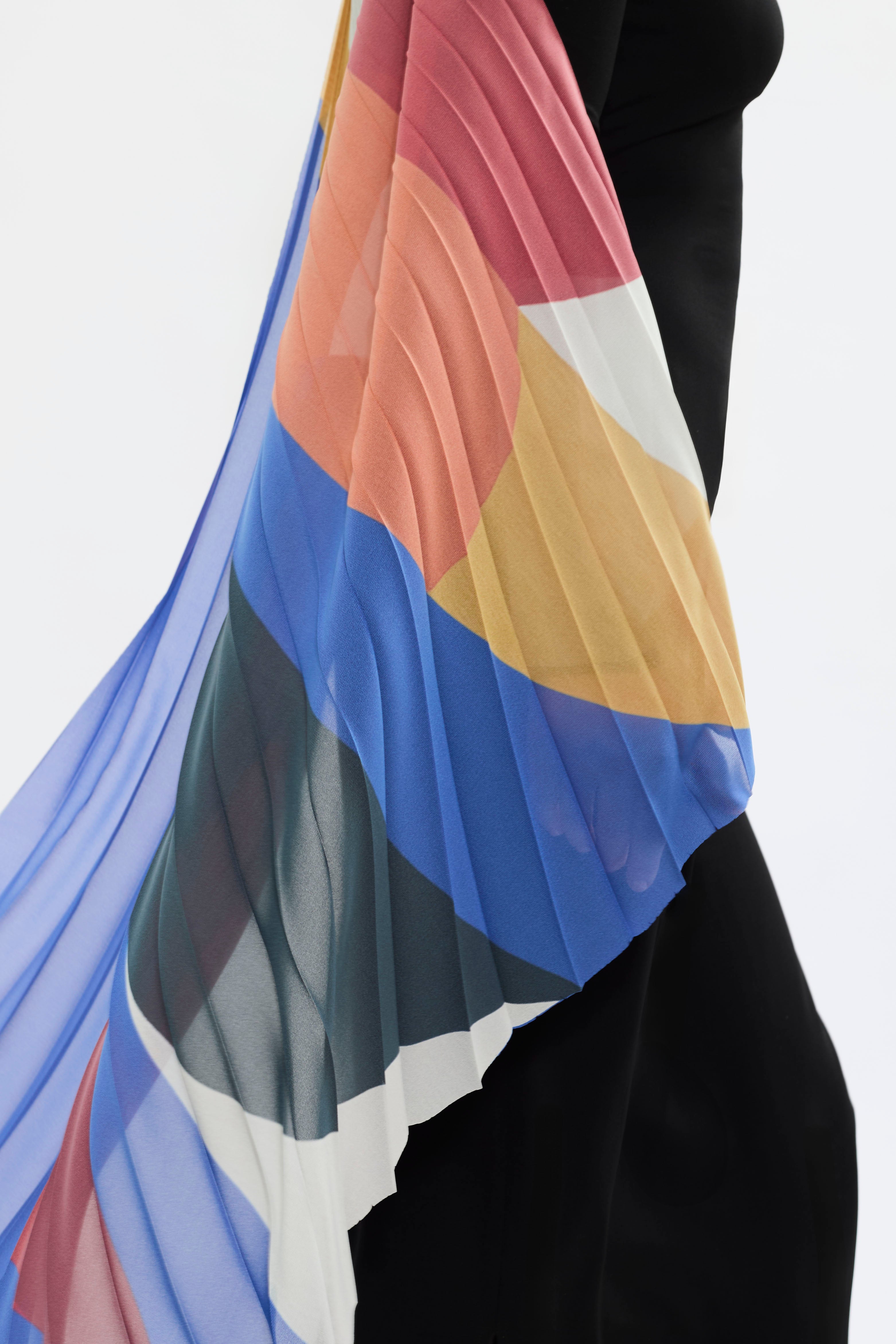 Details of AYT STUDIO x French painter REMED 'ENVOL' long, maxi dress in a fluid jersey fabric with asymmetrical single sleeve, pleated, sculptural graphic patterned panel. Inspired by the painting 'Bel Envol.'