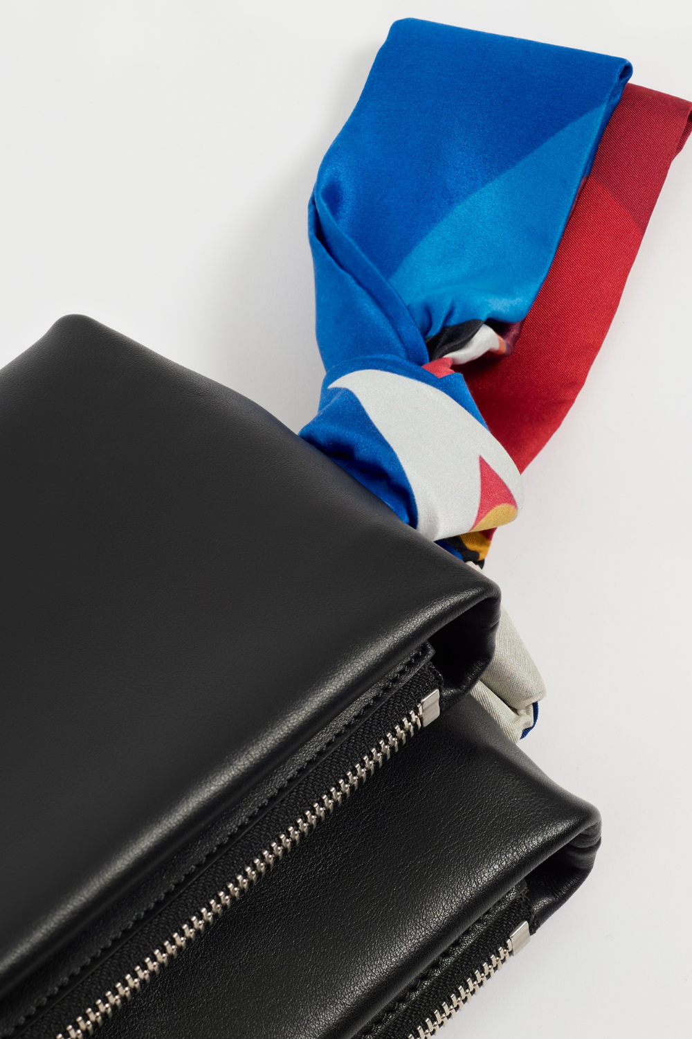AYT Studio x REMED 'FOULARD' Baguette, made of smooth black Italian leather with close up of the vibrant silk scarf handle.