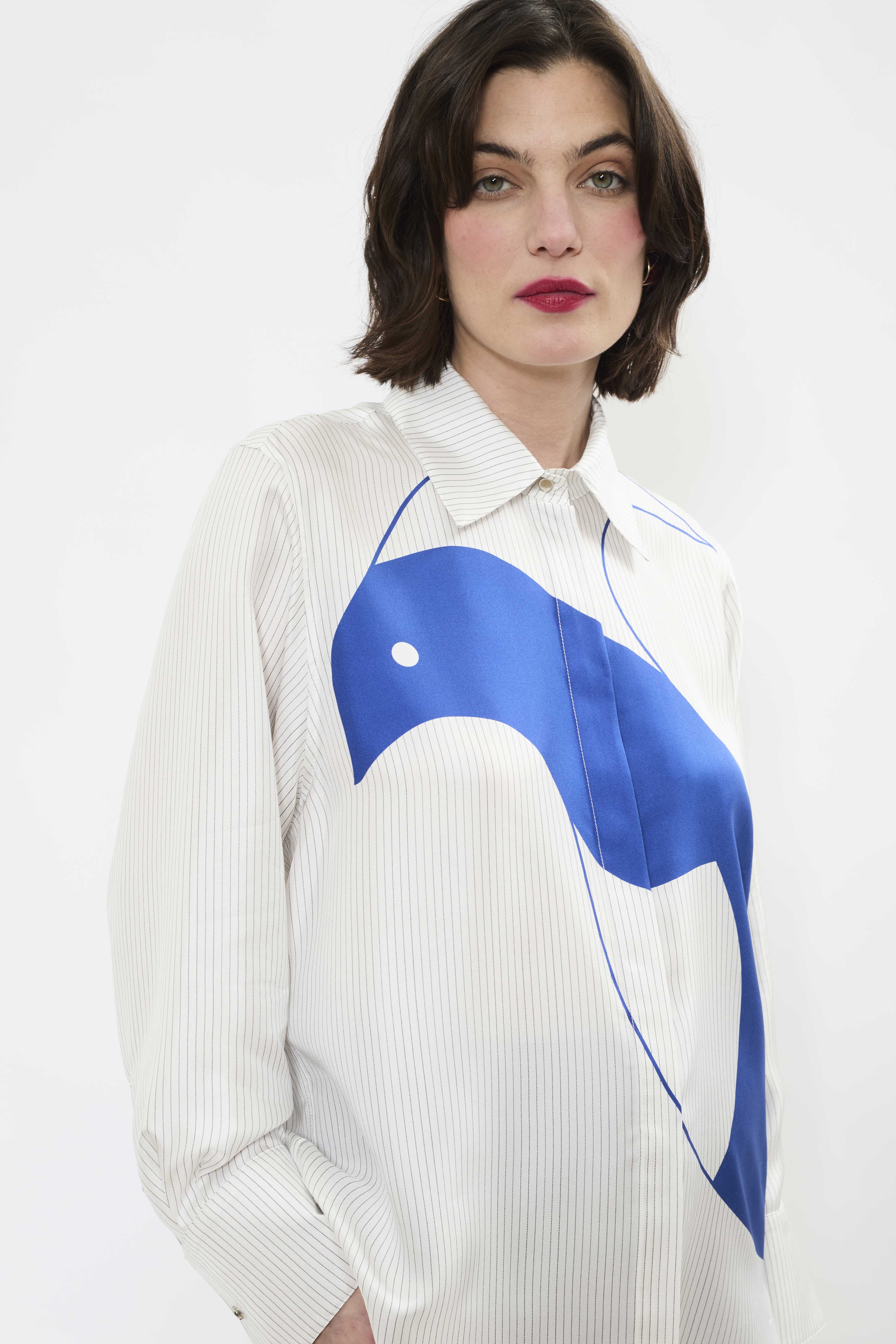 Close up of AYT STUDIO x REMED lightweight 100% Italian silk pinstripe shirt with an artistic design inspired by the painting 'Three Birds. The Blue.'