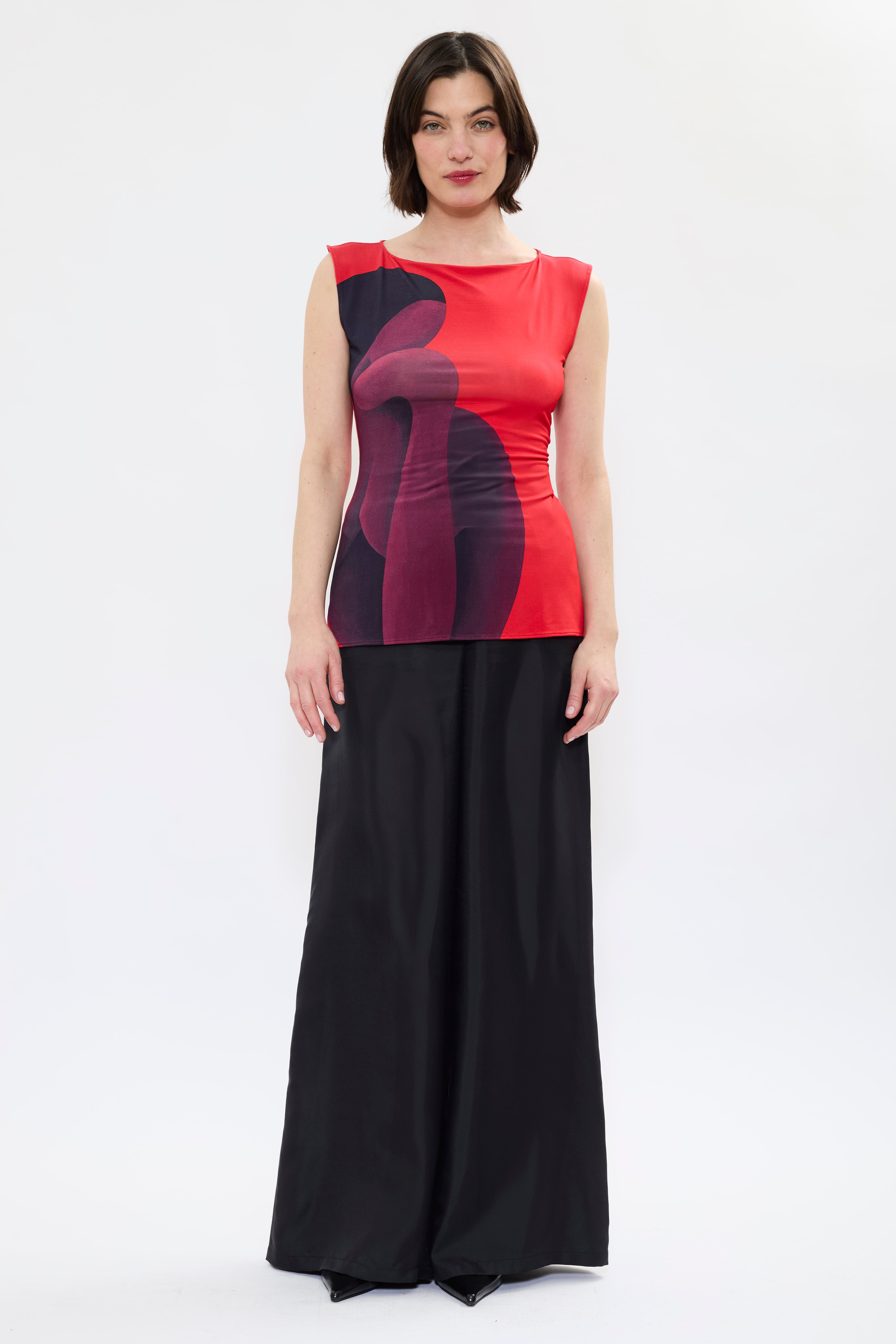 Front view of AYT STUDIO X REMED 'MUSE' tank top in deep reds and black with a fitted, sleeveless silhouette, and boat neckline that highlight the elegance of the cut with a bold artistic print.