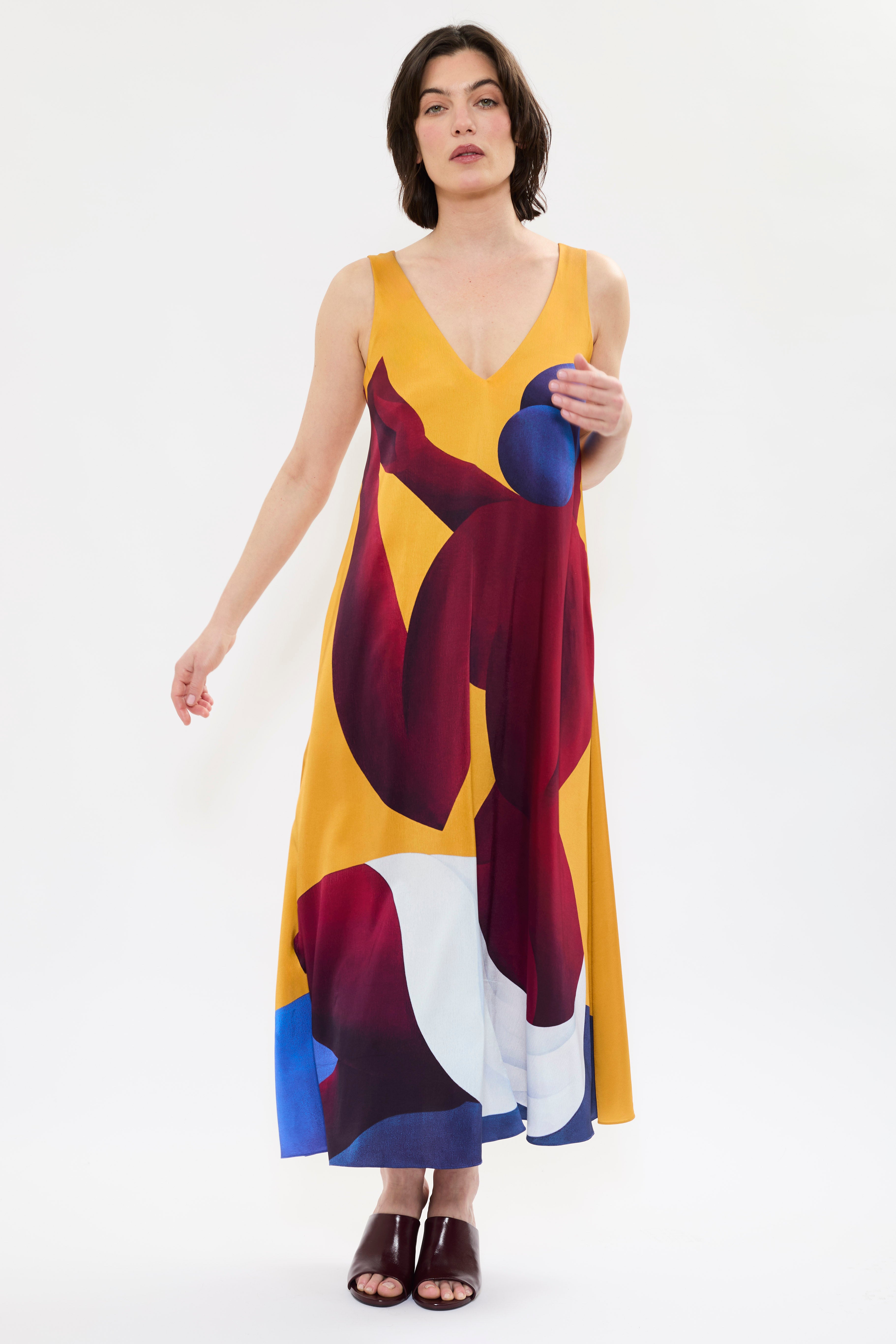 AYT Studio x French artist REMED 'SORORITY' fluid, vibrant yellow printed dress in viscose and elastane with punging V-neck front and back and discreet side pockets. Inspired by REMED's 'Bain de sable.'