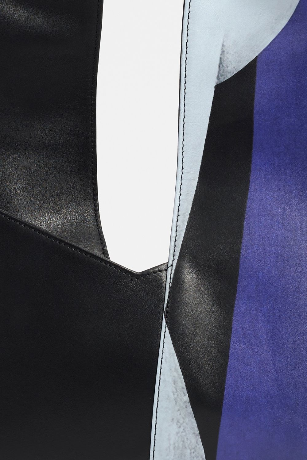 Details of AYT Studio x Remed 'TEMPERANCE' shoulder bag made of black printed leather and blue canvas lining with zipped pockets and asymmetrical scarf-style handle