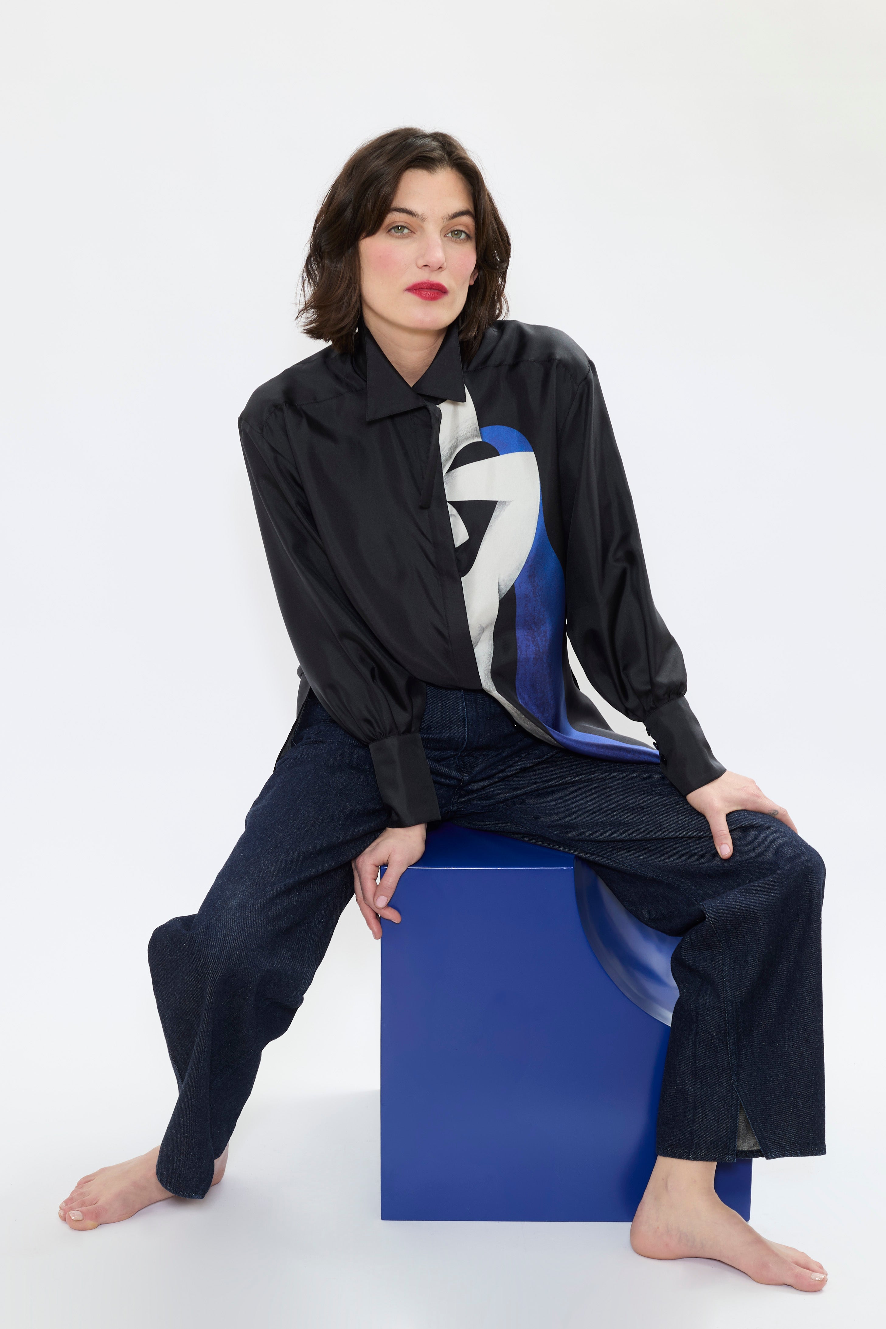 Woman styling AYT STUDIO x REMED lightweight black 100% silk shirt with an artistic design inspired by the painting 'Temperance' with broken collar and wide tightened cuff.