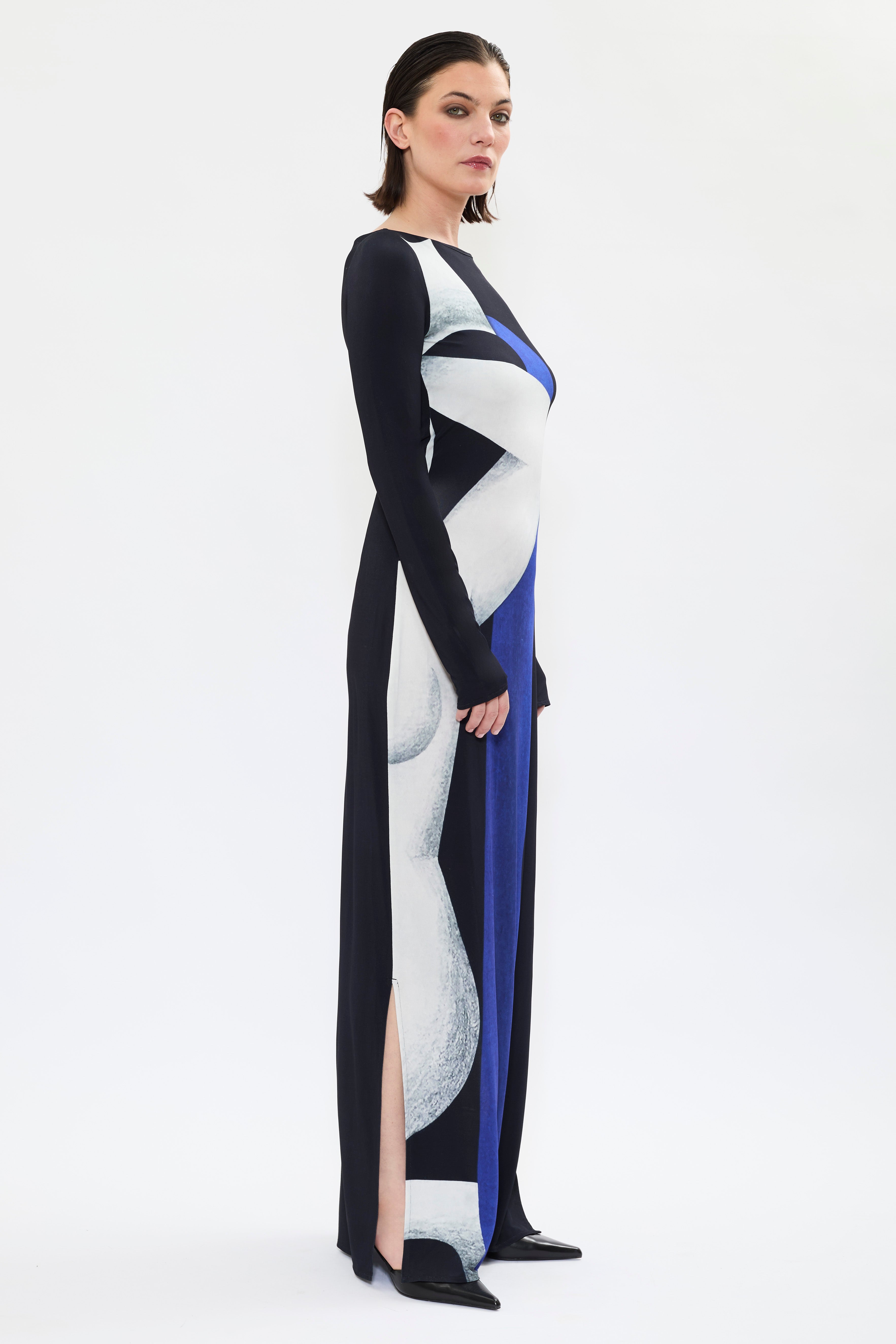 Side view of AYT STUDIO X REMED 'Temperance' dress with a fluid silhouette, long sleeves and boat neckline highlight the elegant simplicity of the cut with a bold artistic print.
