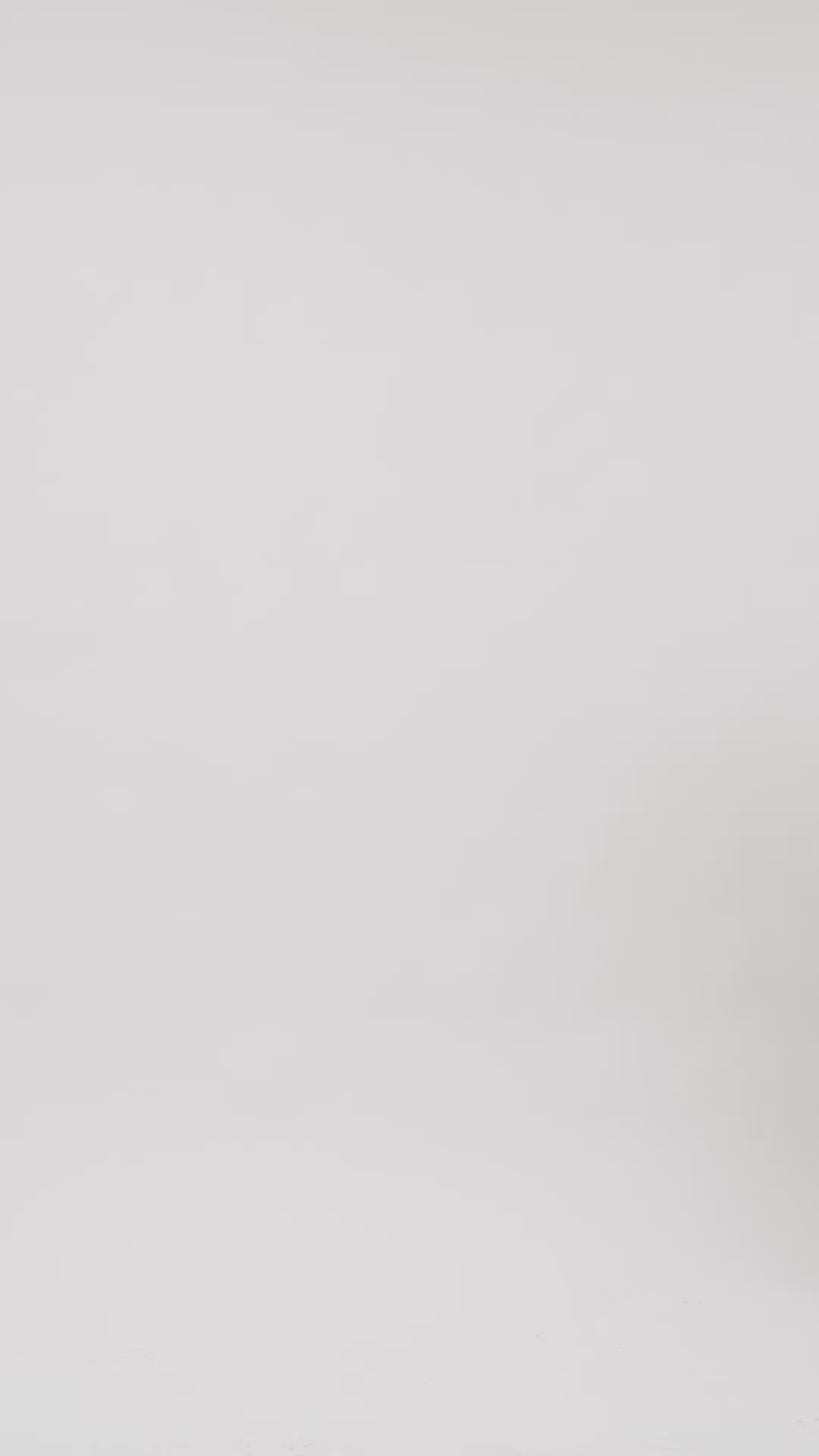 Model wearing AYT Studio x Remed white organic cotton T-shirt dress with line-art print and a straight, oversized fit styled with AYT Studio 'DUAL' shoulder bag.