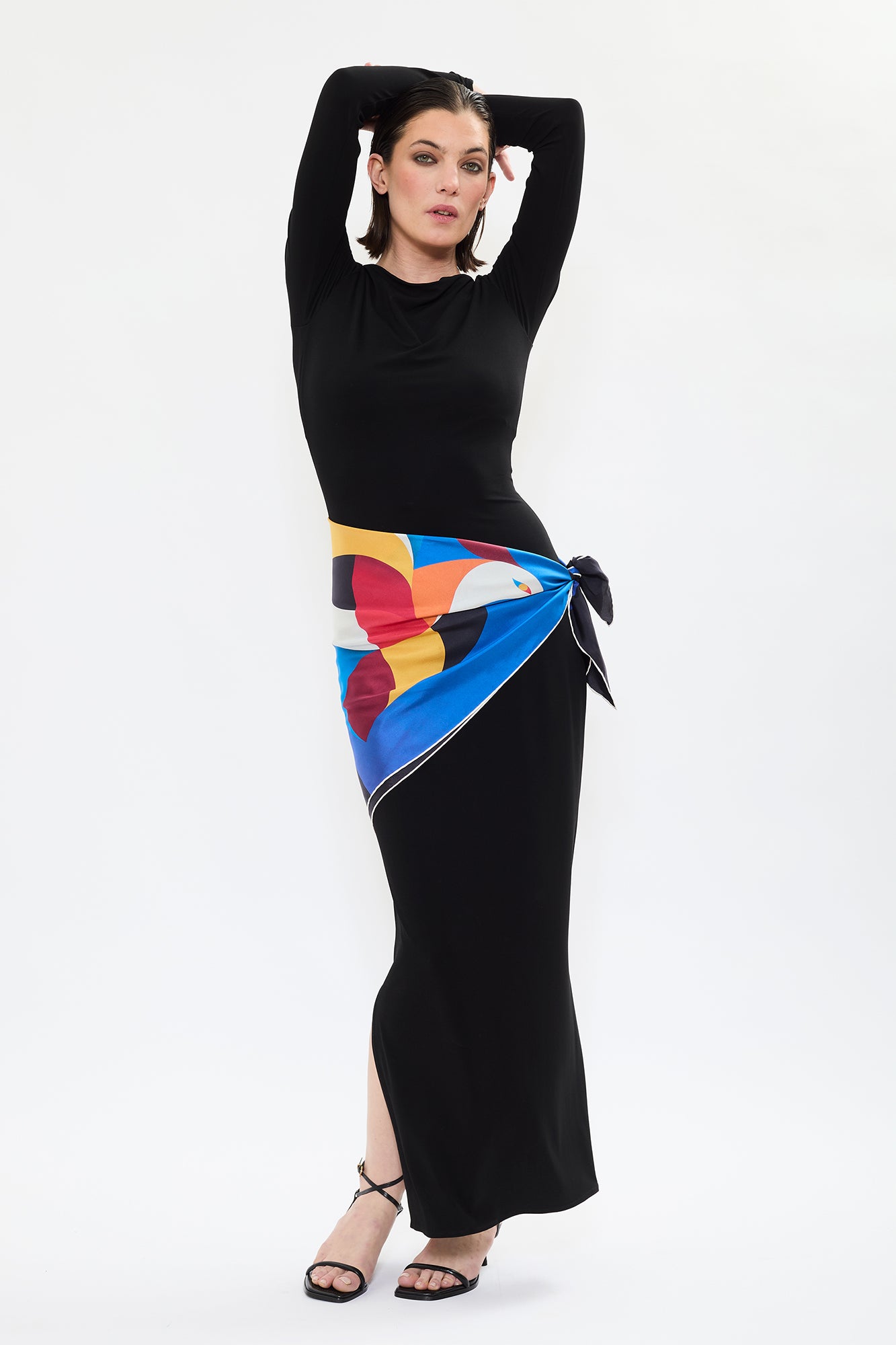 Model wearing AYT STUDIO x French painter REMED 100% twill silk scarf crafted in Como, Italy in a stylized, colorful graphic print inspired by REMED's painting  ‘Bel Envol.' Fluid, versatile accessory for styling. 85 x 85 cm.