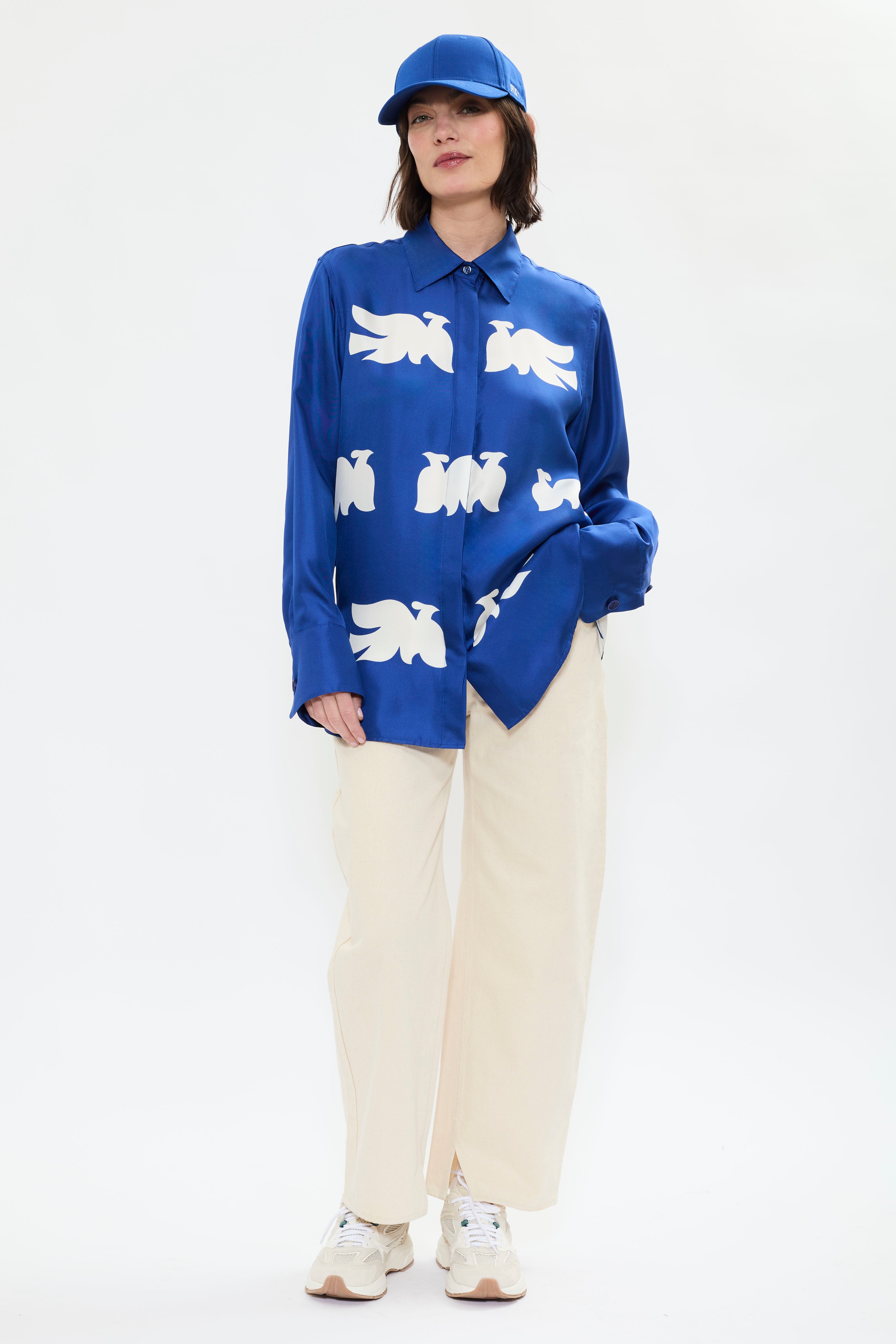 AYT Studio x French artist REMED 'CLOUD OF BIRDS' 100% twill silk button down shirt with structured collar, long sleeves. Lightweight and versatile for day-to-night, relaxed, unisex style. Inspired by REMED's 'Bel Envol.'