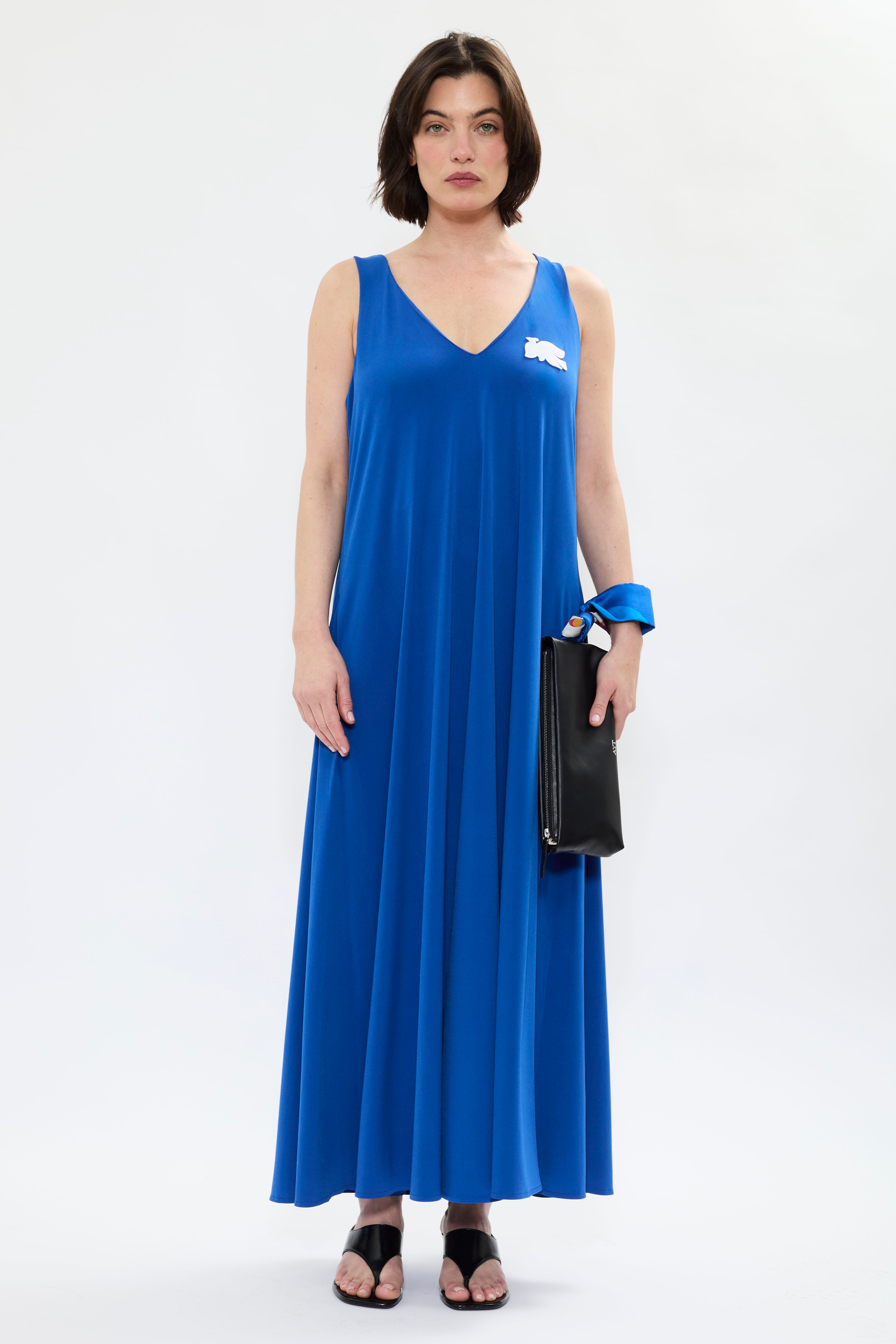 AYT Studio x French artist REMED 'MIRAGE' fluid blue dress in with plunging V-neck front and back, discreet side pockets, and white bird embroidery. Inspired by REMED's 'Ben Envol.'