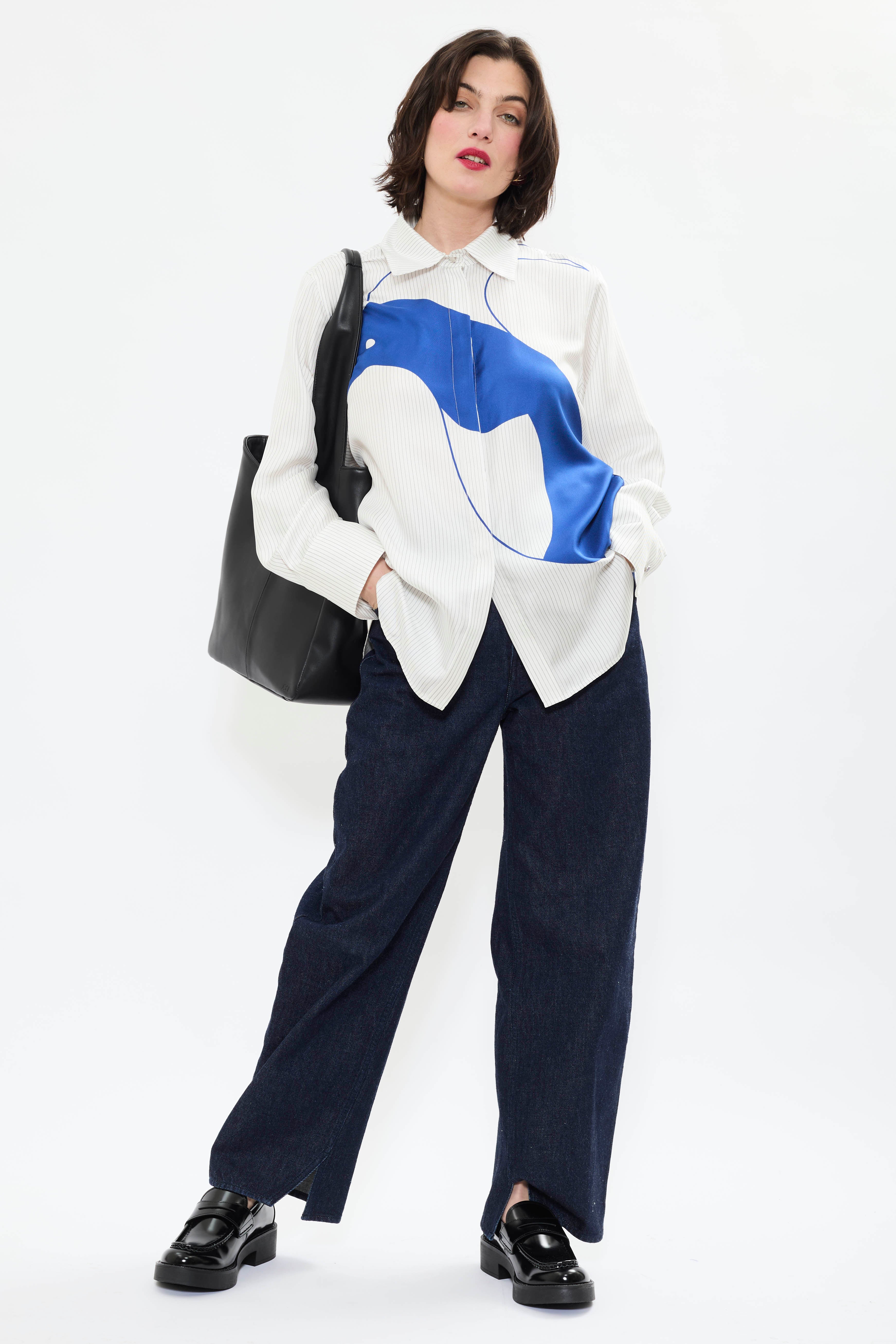 Model wearing of AYT STUDIO x REMED lightweight 100% Italian silk pinstripe shirt with an artistic design inspired by the painting 'Three Birds. The Blue.'