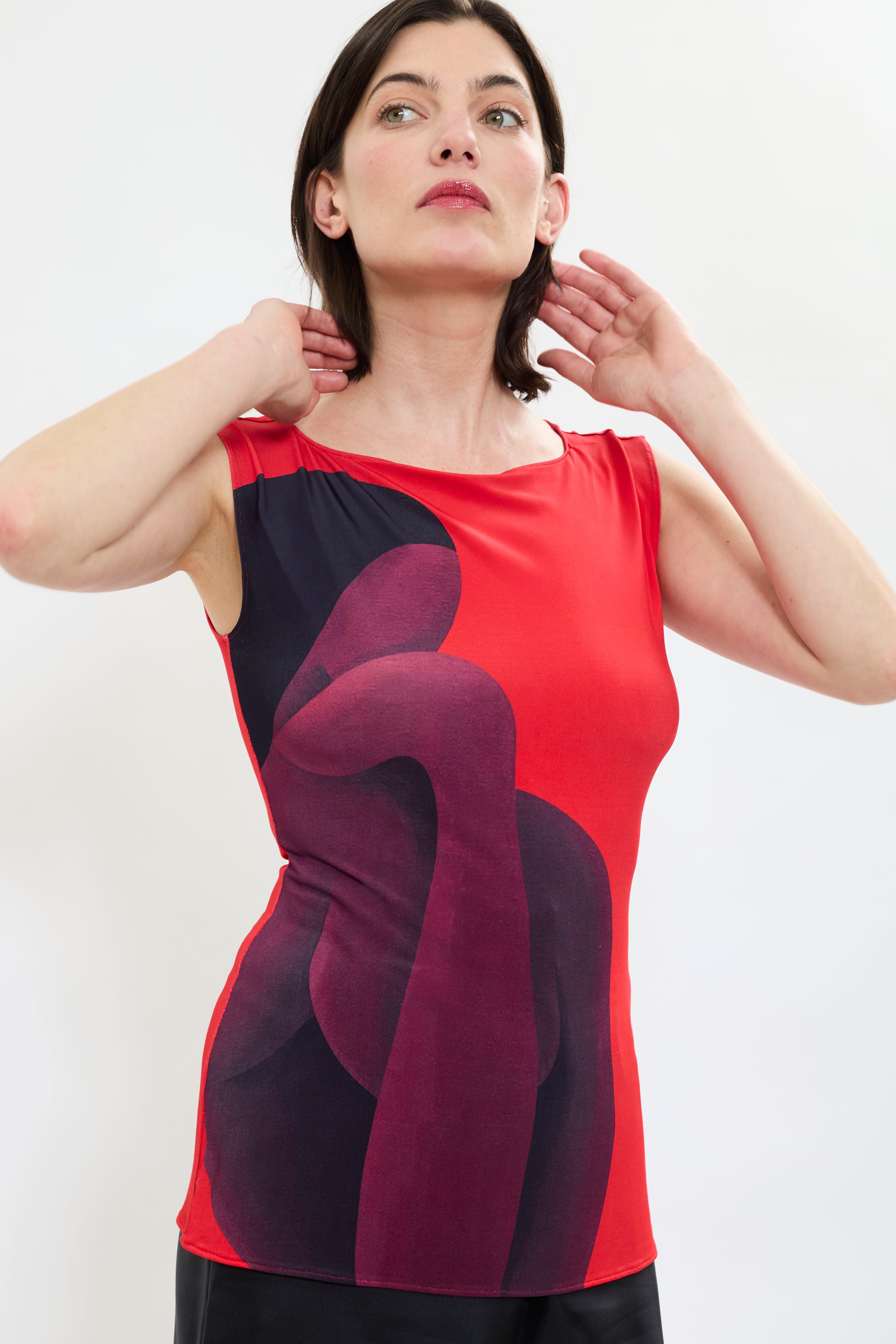 Close up of AYT STUDIO X REMED 'MUSE' lightweight viscose tank top in deep reds and black with a fitted, sleeveless silhouette, and boat neckline that highlight the elegance of the cut with a bold artistic print.