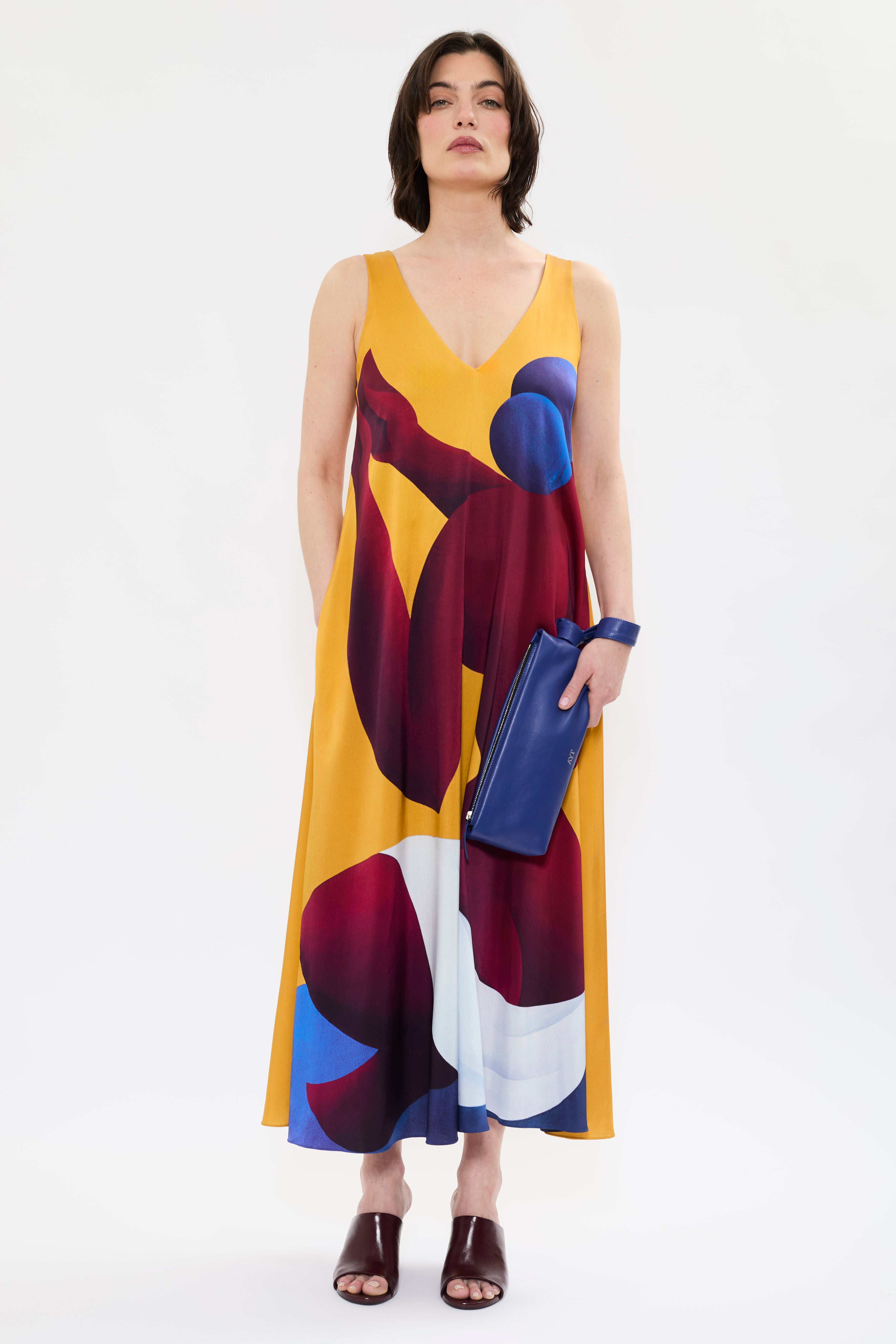 AYT Studio x French artist REMED 'SORORITY' fluid, vibrant yellow printed dress in viscose and elastane with punging V-neck front and back and discreet side pockets. Inspired by REMED's 'Bain de sable.'