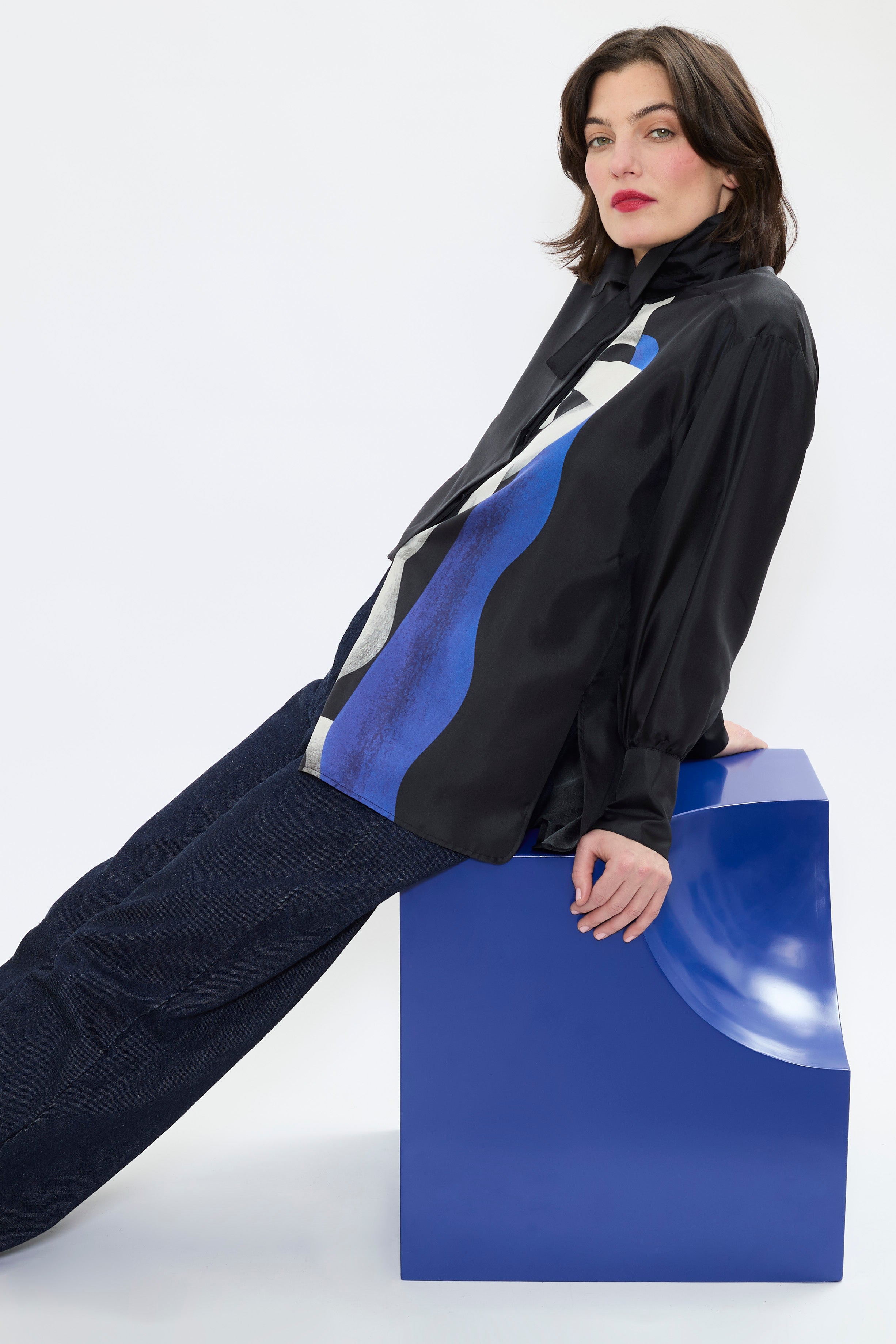 Side view of AYT STUDIO x REMED lightweight black 100% silk shirt with an artistic design inspired by the painting 'Temperance.' Straight fit with broken collar, wide tightened cuff, and delicate gathers at shoulders and cuffs.